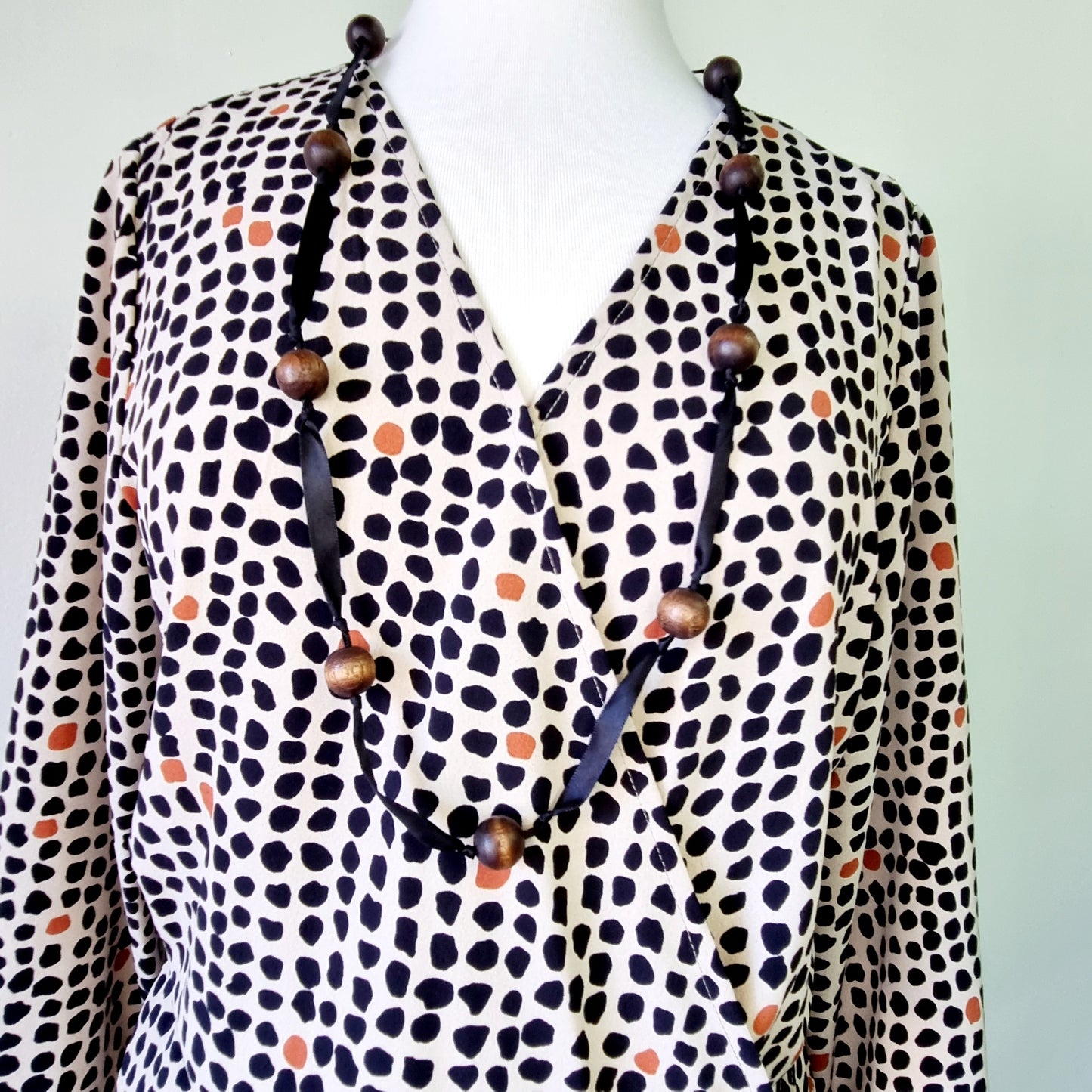 Real Woman - Black, beige & orange dotted print elastic waisted wrap dress.