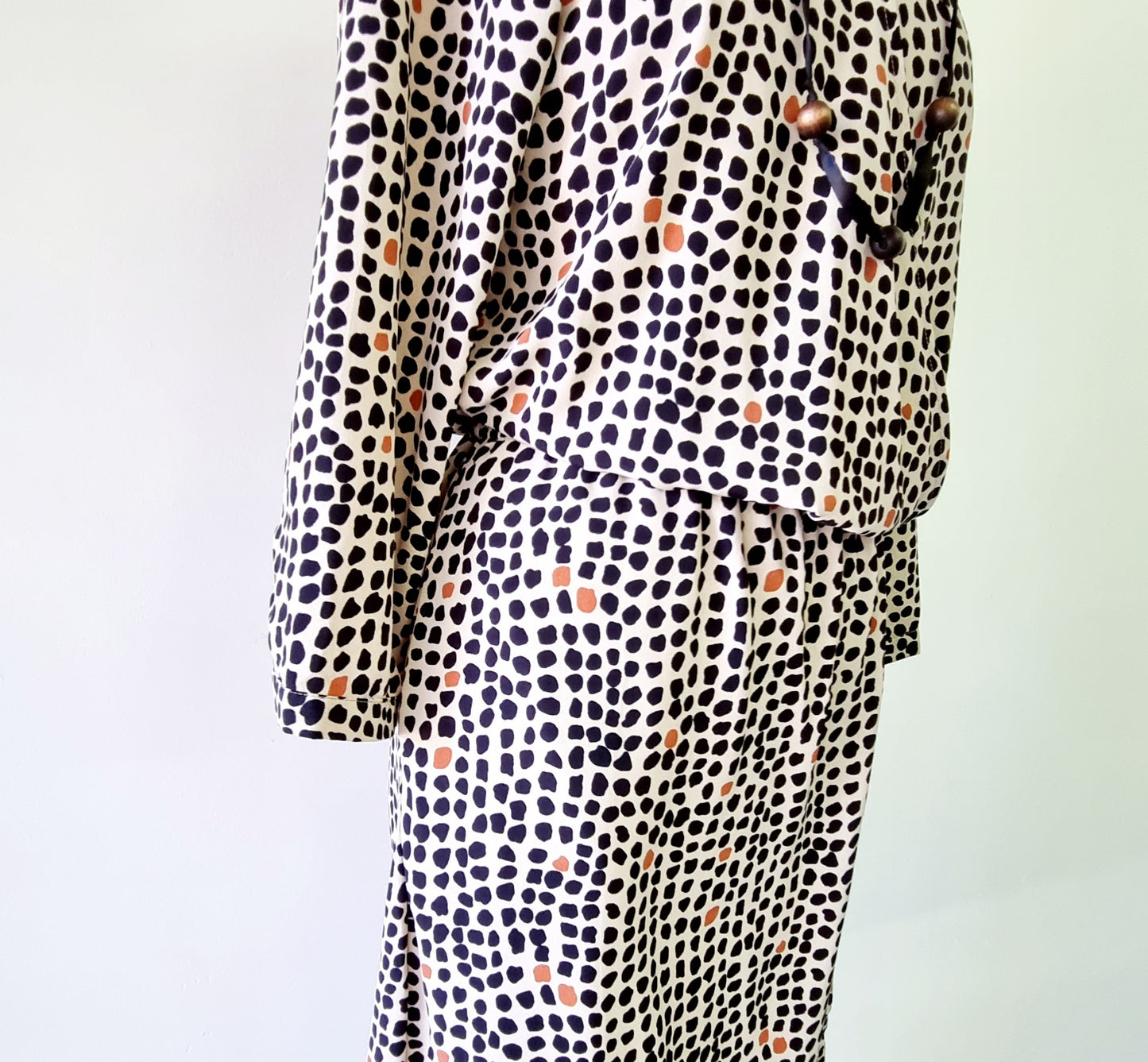 Real Woman - Black, beige & orange dotted print elastic waisted wrap dress.